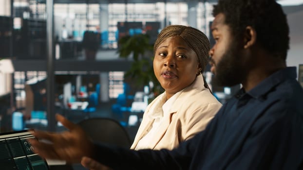 Angry manager in office berating worker for not hitting revenue key performance targets. Upset management executive fighting with employee at work scolding him for low output, camera A