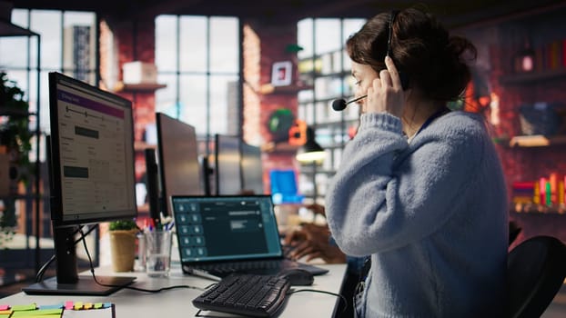 Customer support agent arriving at work, entering office, assisting customers with inquiries. Call center employee sitting down at PC desk, starting account management tasks, camera B