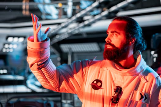 Astronaut reacting to red light alert signals during security breach inside orbital station. Starship crew member responds to unknown threat detected during perimeter scan against hazards