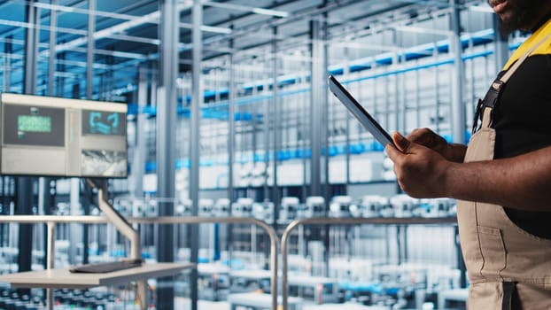 Industry 4.0 photovoltaics plant admin using digital device app to maximize solar energy generation, closeup. Specialist overseeing solar panels smart factory machinery, camera A