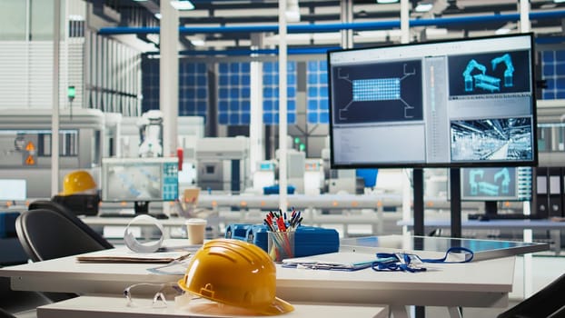 Display in empty photovoltaics factory monitoring system performance. Monitor in sustainable solar panels manufacturing plant tracking energy production and efficiency, dolly out shot