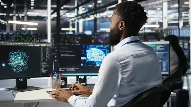 Server hub engineering team interprets AI generated data analytics graphs. Teamworking data center colleagues using artificial intelligence program showing predictive system metrics, camera A