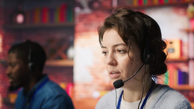 Customer support workers doing upselling, recommending products to clients during conversation. Call center agents contact prospects to inform them about new services and promotions, camera A close up