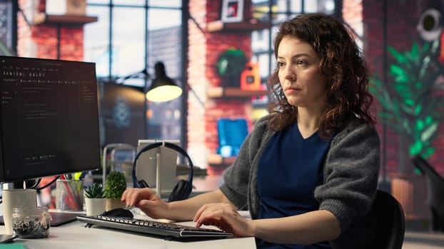 IT female technician uses coding language on computer at the agency, creating software to work on implementing algorithms. IT expert building applications with a programming interface. Camera B.