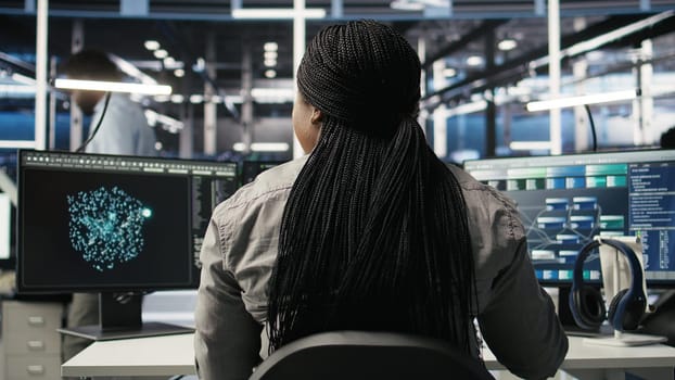 Data center worker applies deep learning node tree programming to analyze datasets for operational insights. Server hub admin uses visual programming to identify patterns in facility data, camera A