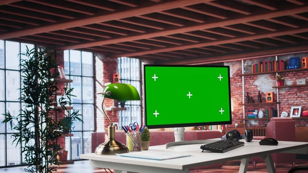 Empty apartment loft with computer running isolated mockup screen, modern workstation at home with bright natural light. Desktop pc showcasing technology and tranquility, cozy vibe.