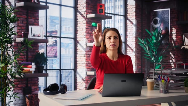 Mature freelancer reviewing holographic images with digital AI innovation, looking at the hologram projection at her home. Woman employs the artificial intelligence visualization. Camera B.