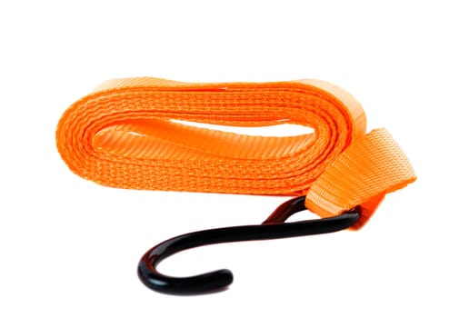 Isolated image of a coiled orange tie-down strap with black hook and metal ratchet. Clean product image for online sales or catalog.