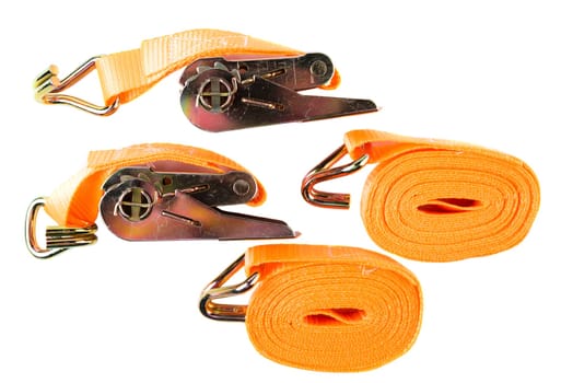 Top view of two coiled orange cargo straps and two ratchets with hooks, arranged on white background. Clean product layout for catalog or store listing.