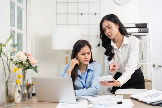 A supportive businesswoman offers guidance to her colleague facing difficulties, emphasizing teamwork and resilience in the workplace.