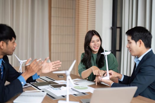 Business team engages in an animated discussion about ESG strategies, emphasizing sustainability and corporate responsibility in a meeting.