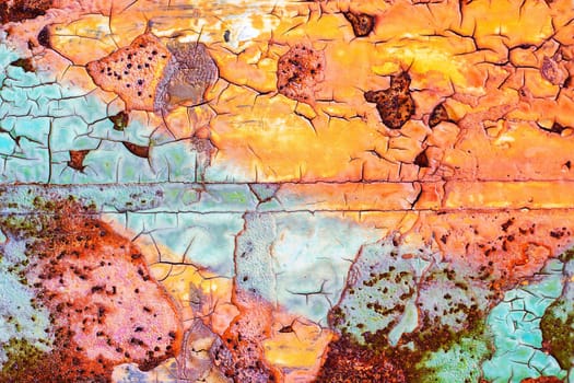 Background of blue and orange cracked old damaged paint texture on a metal surface. High quality photo