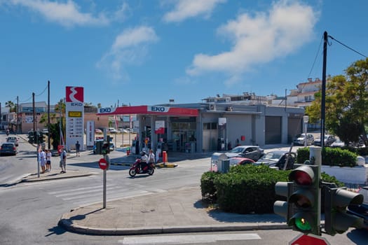 Rhodes. Greece - June 06, 2025: An EKO gas station with cars and motorcycles refueling on a busy street in Rhodes. The image captures daily life and urban movement.