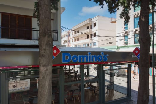 Rhodes. Greece - june 06, 2025: A Domino's Pizza branch in Rhodes, Greece, showing the restaurant facade with trees and an urban setting, reflecting the presence of international chains.