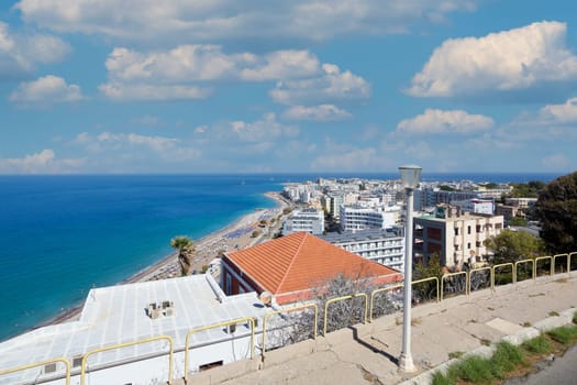 Rhodes. Greece - June 06, 2025: Vibrant scene of Rhodes city from an elevated viewpoint, capturing urban life alongside the serenity of the Mediterranean.