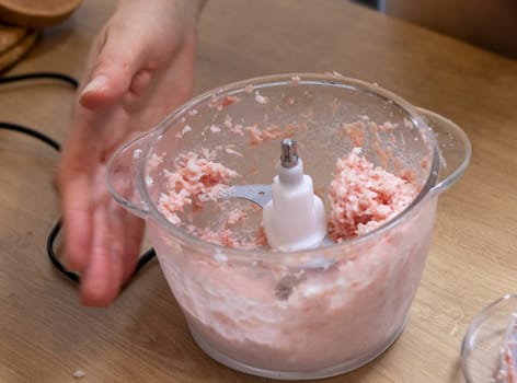 Just ground meat mince in the glass bawl of the electrical chopper on the kitchen counter top