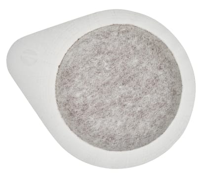 White, round coffee pod or Easy Serving Espresso pod, filled with ground coffee, isolated background