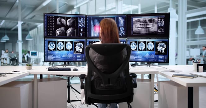 Neurology Doctor Using Radiology Monitoring Computer To Look After Patient's Brain