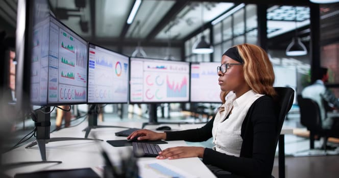 Focused African American Woman Analyzing Stock Market Data On Computer