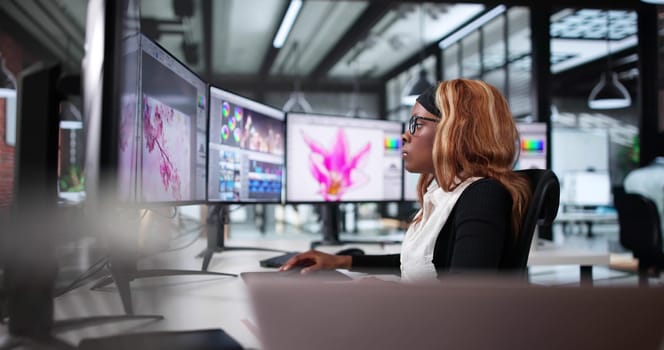 African American Woman Editing Photos On Computer Screen In Office.