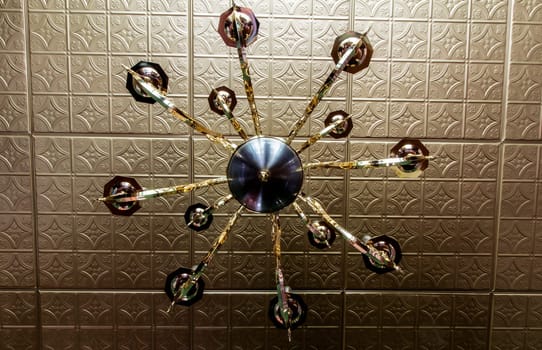 View of a Light Fixture That is Underneath a Tin Ceiling