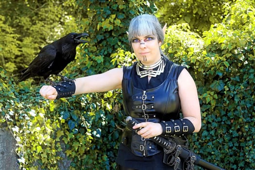 Fantasy photo of a dark elf with a raven on her hand