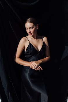 Beautiful slim fashion woman in black summer silk dress