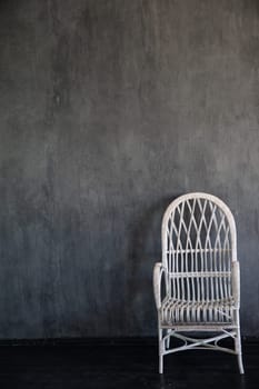 White vintage armchair in the interior of a gray room