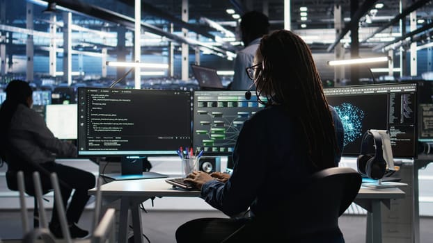 Data center expert examines node tree interface, delivering technical support. Server room technician talking in headset mic with coworkers, using visual programming software, camera A