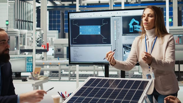 Executives and investors in photovoltaics plant reviewing solar technology reports, discussing future investment opportunities in renewable energy manufacturing, camera A