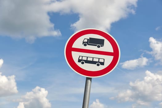 No entry for buses and trucks traffic sign against cloudy bright blue sky