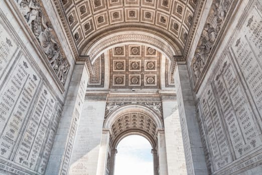 France, Paris - May 03, 2025 - The magnificent details of ornate stone carvings under the arch of the famous Arc de Triomphe. Iconic touristic architectural landmark of Paris, use it as your Wallpaper, Poster and Space for text, Selective focus.