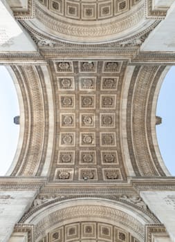 France, Paris - May 03, 2025 - Upward View to the ornate stone carvings ceiling centre inside of the famous Arc de Triomphe. Stunning details under the arch of Triumphal Arch, Iconic touristic architectural landmark of Paris, use it as your Wallpaper, Poster and Copy space, Selective focus.