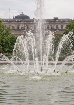 France, Paris - May 03, 2025 - View of Fountain in the Jardin du Palais Royal with the Palais Royal building and sky in the backhground. known as "Fontaines de Pol Bury" use it as your Wallpaper, Poster and Copy space, Selective focus.