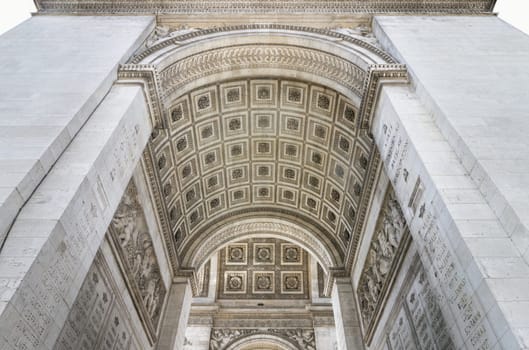 France, Paris - May 03, 2025 - The stunning details of ornate stone carvings under the arch of the famous Arc de Triomphe. Iconic touristic architectural landmark of Paris, use it as your Wallpaper, Poster and Copy space, Selective focus.