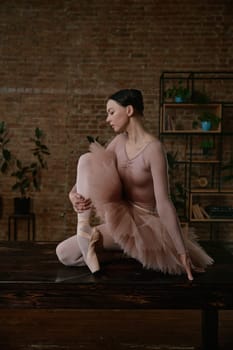 A stunning ballet dancer elegantly showcases her impressive technique in a stylish and artistic indoor space