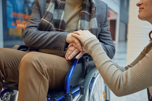 A profoundly heartfelt moment of connection takes place between a dedicated caregiver and a person in a wheelchair