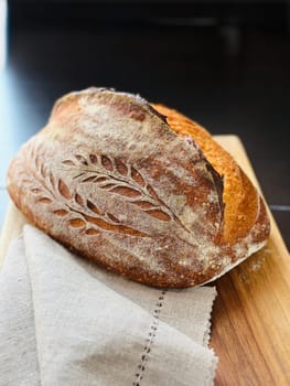 close view of a freshly baked sourdough bread with a textured, golden crust. High quality photo