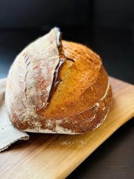 close view of a freshly baked sourdough bread with a textured, golden crust. High quality photo