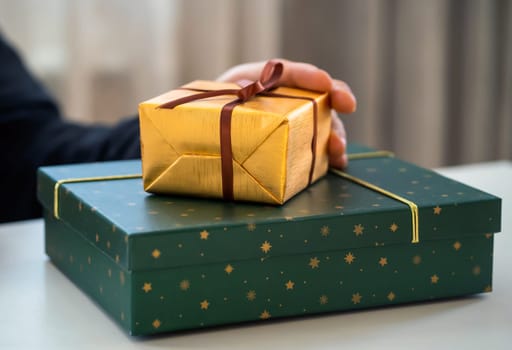 Male hands hold gifts in beautiful wrapping paper closeup view, a man prepares gifts for his loved one, relatives, friends and family for celebration the holiday.