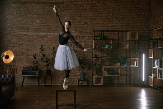 A graceful ballerina showcases her balance and skill in a modern studio with a minimalist backdrop enhancing her art