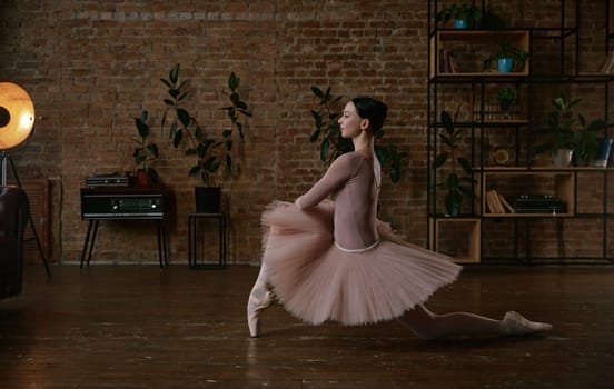 A breathtaking ballet dancer gracefully poses in a stylish, rustic studio filled with beautiful natural light