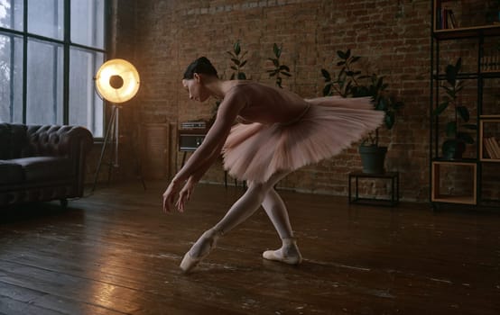 A graceful ballet dancer exhibiting elegance and poise within a peaceful, beautifully lit studio environment