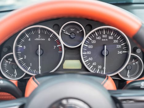 Close-Up View of a Sports Car Dashboard Displaying Gauges