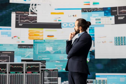 Modern business leader thinking about new successful ideas to increase his company profits, using insight and KPI projections or models to help guide strategic decision making.