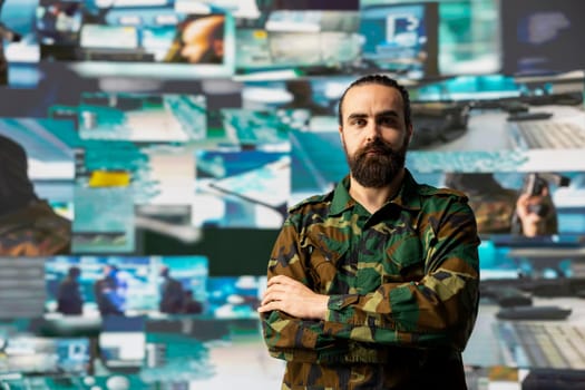 Military personnel examines data from satellite and creates tactical operations, high tech control center for a mission. Soldier uses threat detection systems and tools for national interests.
