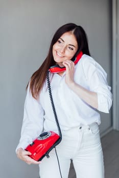 brunette talking on red phone and smiling