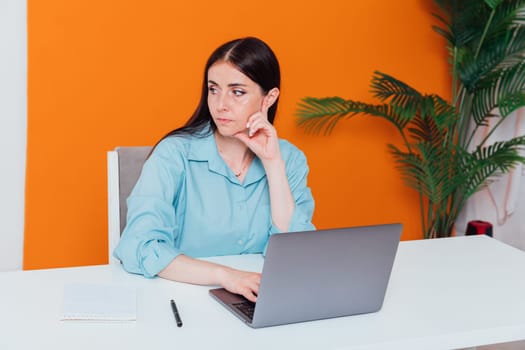 Business woman working on laptop at office desk online