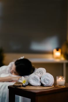 Relaxed lady at spa with focus on spa equipment. Wellness concept.