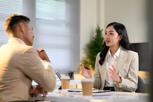Two colleague discussion on office workplace.
